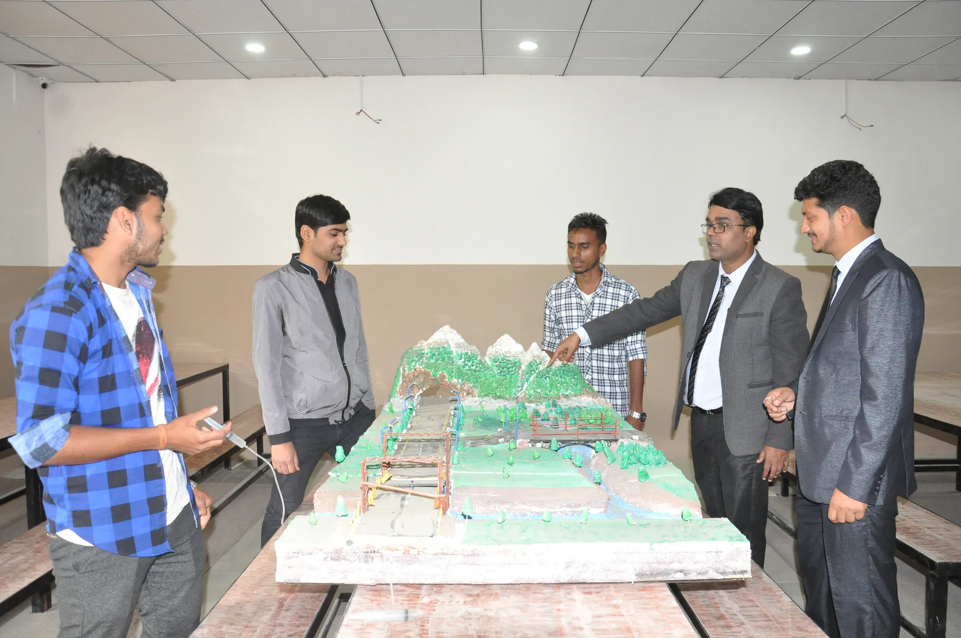 Civil engineering students presenting and discussing a project model
