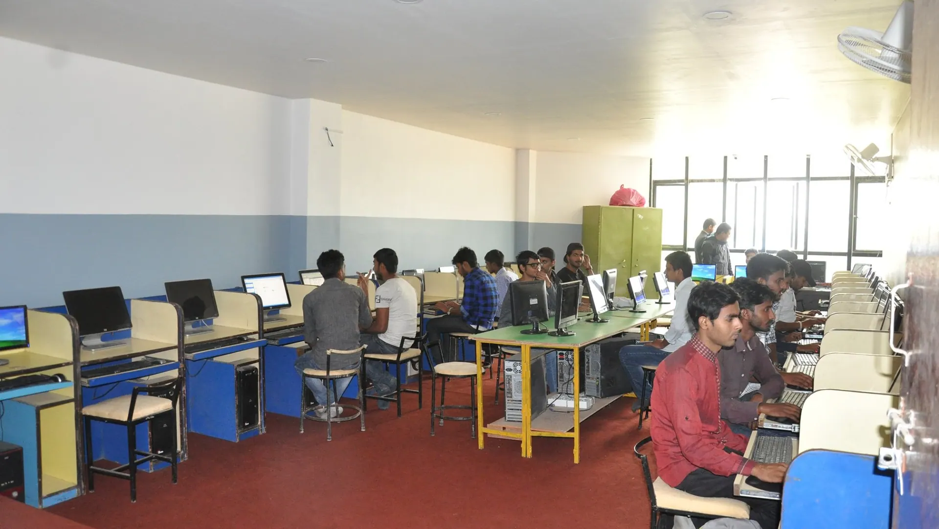 Computer engineering students at work along the desktop benches of the ICE laboratory