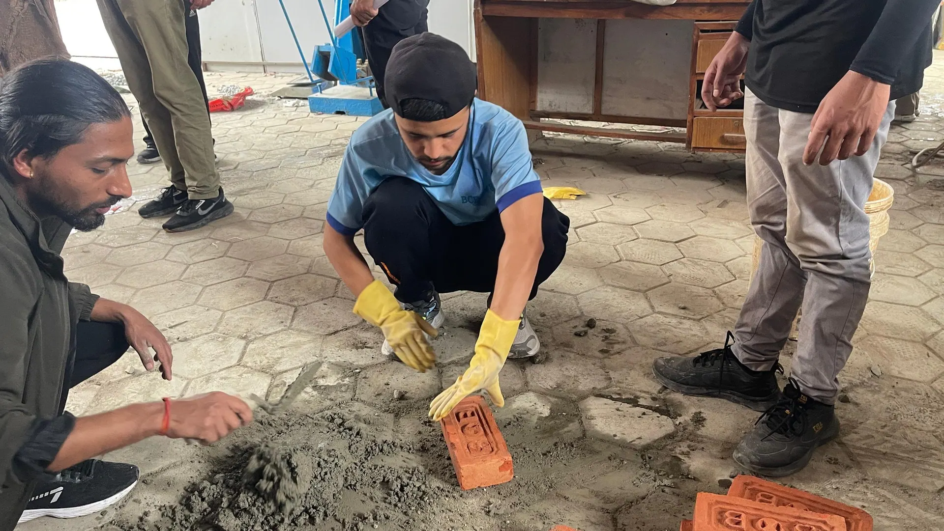 Civil Engineering students working mortar and brick during a materials practical