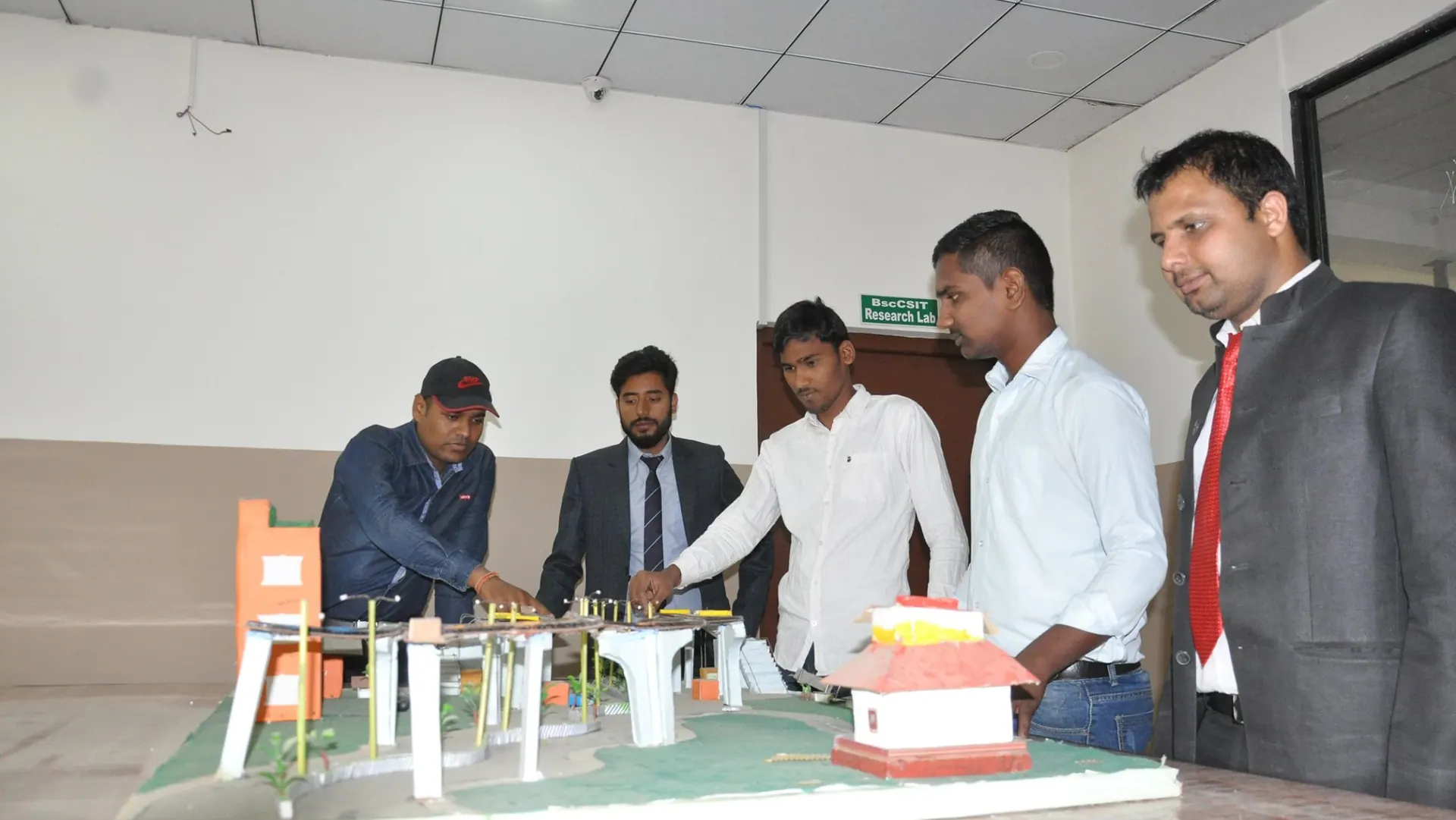 Students presenting and reviewing a civil engineering model
